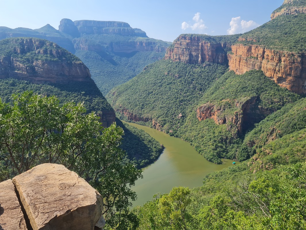 Panoramic view over Blyde River Canyon with green cliffs and the river below