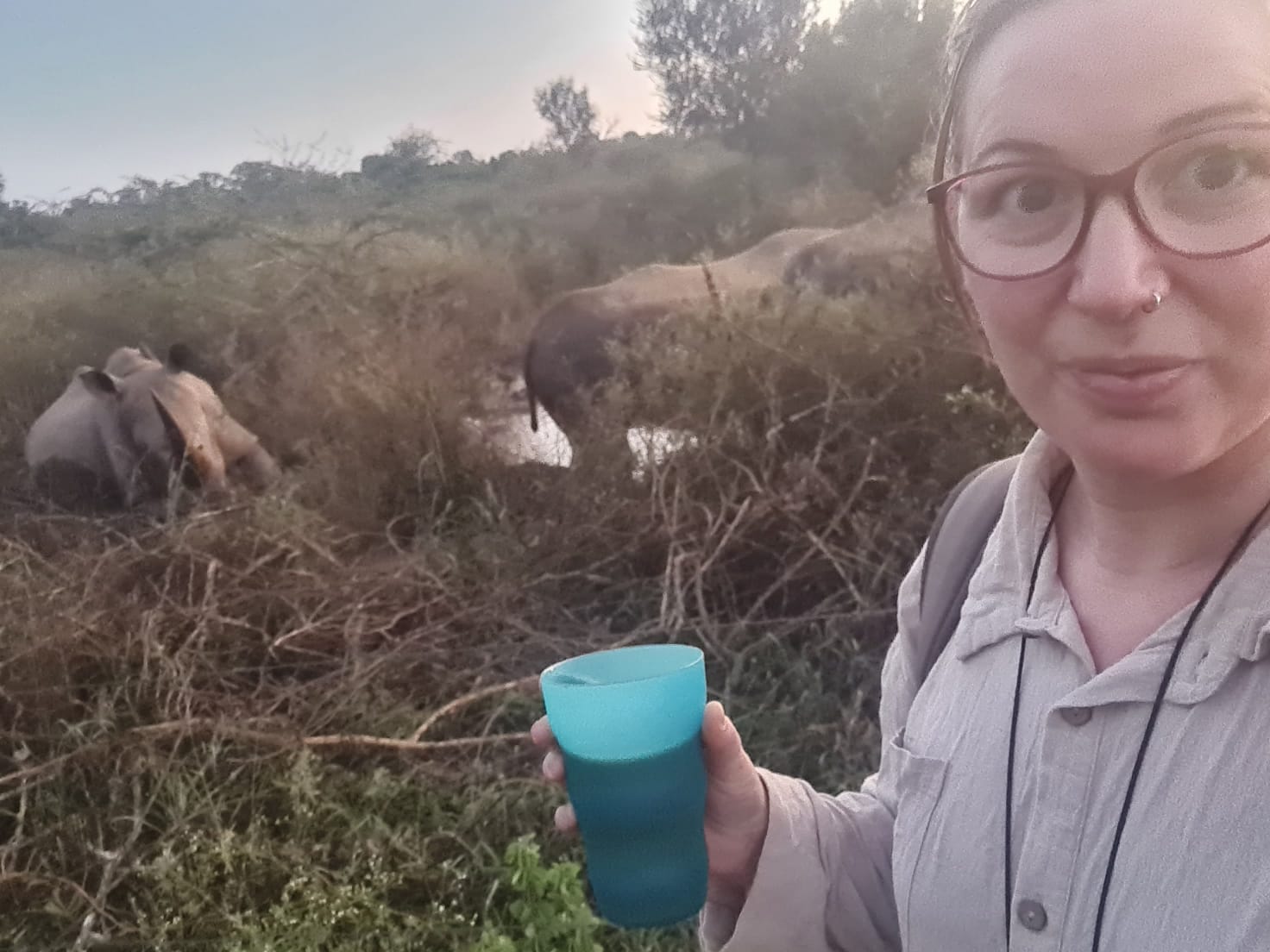 Erica on safari with a rhino in the background